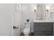 Elegant half bathroom with gray vanity, white marble countertop, and modern fixtures at 2013 E Solano Dr, Phoenix, AZ 85016