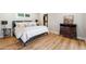 Comfortable bedroom with hardwood floors, closet, and stylish dresser at 2013 E Solano Dr, Phoenix, AZ 85016
