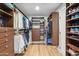 Spacious walk-in closet with custom shelving, drawers, and ample storage for clothes and accessories at 2013 E Solano Dr, Phoenix, AZ 85016
