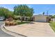 Expansive property showcasing a wide driveway leading to a two-car garage and a well-maintained lawn at 2013 E Solano Dr, Phoenix, AZ 85016