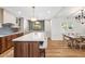 Modern kitchen with white cabinets, a large island, and an adjacent dining area at 2013 E Solano Dr, Phoenix, AZ 85016