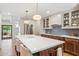 Kitchen island boasting a white countertop, wooden base with seating and stainless appliances at 2013 E Solano Dr, Phoenix, AZ 85016