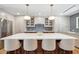 Large kitchen island with quartz countertop, seating, and stylish pendant lighting at 2013 E Solano Dr, Phoenix, AZ 85016