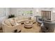 Bright living room featuring a large curved sofa, hardwood floors, and natural light at 2013 E Solano Dr, Phoenix, AZ 85016