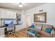 Stylish home office featuring custom cabinets, desk, hardwood floors, and comfortable sofa at 2013 E Solano Dr, Phoenix, AZ 85016