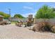 Landscaped patio featuring brick pavers, an outdoor fireplace, and comfortable seating for entertaining at 2013 E Solano Dr, Phoenix, AZ 85016