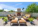 Inviting patio with brick pavers, an outdoor fireplace, and ample seating for relaxing and socializing at 2013 E Solano Dr, Phoenix, AZ 85016