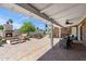 Charming covered patio with brick pavers, fireplace, and comfortable outdoor seating area at 2013 E Solano Dr, Phoenix, AZ 85016