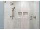 Modern shower featuring subway tile surround, dual shower heads, and built-in shelving niches at 2013 E Solano Dr, Phoenix, AZ 85016