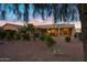 Exterior view of covered patio in backyard with desert landscaping at 20160 N Riverbank Rd, Maricopa, AZ 85138