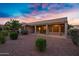 Covered patio in backyard with desert landscaping and stunning sunset at 20160 N Riverbank Rd, Maricopa, AZ 85138