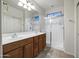 Bathroom with double sink vanity, large mirror, and spacious walk-in shower at 20160 N Riverbank Rd, Maricopa, AZ 85138