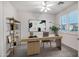 Well-lit home office with a modern desk, stylish decor, and shutters at 20160 N Riverbank Rd, Maricopa, AZ 85138