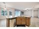 Kitchen island with granite countertops, stainless steel dishwasher, a double sink, and wood cabinets at 20160 N Riverbank Rd, Maricopa, AZ 85138