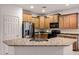 Kitchen featuring stainless steel appliances, granite countertops, wood cabinets, and a kitchen sink at 20160 N Riverbank Rd, Maricopa, AZ 85138