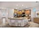 Spacious kitchen with granite countertops, wood cabinets, and a breakfast bar with seating for four at 20160 N Riverbank Rd, Maricopa, AZ 85138