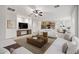 Open-concept living space showcasing neutral paint colors, an accent rug, and contemporary decor at 20160 N Riverbank Rd, Maricopa, AZ 85138