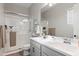 Bathroom featuring a walk-in shower, double sink vanity, and updated fixtures for a sleek look at 20563 E Carriage Way, Queen Creek, AZ 85142