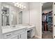 This updated bathroom has vanity space, modern fixtures, and walk in closet at 20563 E Carriage Way, Queen Creek, AZ 85142
