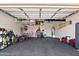 Well-organized garage with overhead storage racks, shelving, and ample space for parking and storage of all your equipment at 20563 E Carriage Way, Queen Creek, AZ 85142