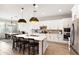 Bright kitchen with white cabinets, a large island, pendant lighting, and modern appliances at 20563 E Carriage Way, Queen Creek, AZ 85142