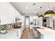 Bright kitchen featuring white cabinetry, quartz countertops, stainless steel appliances, and an island with bar seating at 20563 E Carriage Way, Queen Creek, AZ 85142