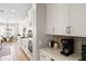 Bright kitchen featuring white cabinetry, modern appliances, and a breakfast nook overlooking the backyard at 20563 E Carriage Way, Queen Creek, AZ 85142