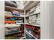 Organized linen closet with shelves stocked with towels, bedding, and storage containers at 20563 E Carriage Way, Queen Creek, AZ 85142