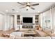 Cozy living room featuring a modern fireplace, built-in shelving, and comfortable seating for relaxation at 20563 E Carriage Way, Queen Creek, AZ 85142