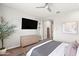 This main bedroom is bright and spacious with an elegant dresser and decorative tree at 20563 E Carriage Way, Queen Creek, AZ 85142