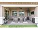 Covered outdoor patio with dining area, ceiling fan, heater, and ample lighting for relaxing and entertaining at 20563 E Carriage Way, Queen Creek, AZ 85142