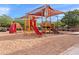 Community playground with sunshades in the neighborhood, including climbing and slide features at 20563 E Carriage Way, Queen Creek, AZ 85142