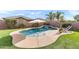 Backyard view of a pool, waterfall feature, lush landscaping, and lounge chairs, perfect for outdoor entertaining and relaxation at 20563 E Carriage Way, Queen Creek, AZ 85142