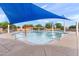 Community splash pool featuring sunshade, playground elements, and seating for hot summer days at 20563 E Carriage Way, Queen Creek, AZ 85142
