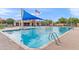 Community splash pool with sunshade and clubhouse surrounded by comfortable seating at 20563 E Carriage Way, Queen Creek, AZ 85142