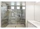 This luxurious bathroom has a spacious shower with rainfall showerhead and built-in niche at 20563 E Carriage Way, Queen Creek, AZ 85142