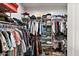 Spacious walk-in closet provides ample storage with shelving and racks for clothing and accessories at 20563 E Carriage Way, Queen Creek, AZ 85142