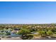 Beautiful aerial view of the community featuring a lake and recreational facilities against a clear blue sky at 21019 N Sansom Dr, Maricopa, AZ 85138