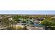 Community aerial view showcases a serene lake, walking paths and lush landscaping with mature trees and lawns at 21019 N Sansom Dr, Maricopa, AZ 85138