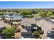 Beautiful aerial view of a two-story home with a lake nearby and well-maintained landscaping at 21019 N Sansom Dr, Maricopa, AZ 85138