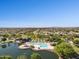 Community aerial showing a large swimming pool, clubhouse, mature landscaping and a scenic lake at 21019 N Sansom Dr, Maricopa, AZ 85138