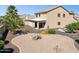 Large backyard with gravel landscaping, a covered patio, and mature palm trees at 21019 N Sansom Dr, Maricopa, AZ 85138