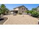Spacious backyard with gravel landscaping, patio area, mature trees, and a view of the house at 21019 N Sansom Dr, Maricopa, AZ 85138
