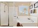 Bright bathroom featuring a separate shower and soaking tub under a window with natural light at 21019 N Sansom Dr, Maricopa, AZ 85138
