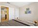 Cozy bedroom with a comfortable bed, stylish artwork, and convenient access to the hallway and closet at 21019 N Sansom Dr, Maricopa, AZ 85138