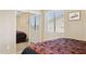 Bright bedroom featuring neutral walls, plush carpet, a window with blinds, and a mirrored closet at 21019 N Sansom Dr, Maricopa, AZ 85138