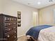 Bedroom featuring a plush blue comforter and dark wood furniture at 21019 N Sansom Dr, Maricopa, AZ 85138