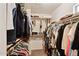 Walk-in closet featuring clothing racks and shelving providing plenty of storage space at 21019 N Sansom Dr, Maricopa, AZ 85138
