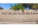 Community entrance sign with 'Summerwind' displayed, set against a stone and stucco wall at 21019 N Sansom Dr, Maricopa, AZ 85138