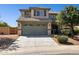 Attractive two-story home with a well-manicured front yard and a two-car garage at 21019 N Sansom Dr, Maricopa, AZ 85138